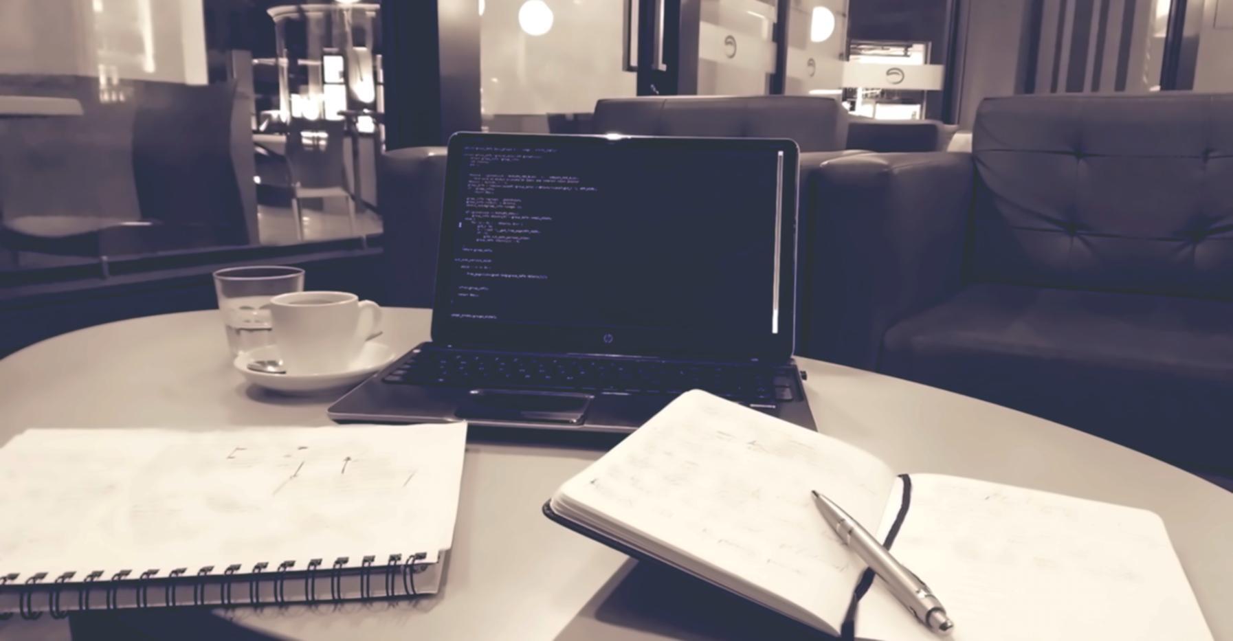 Mobile app development and support workspace showing multiple devices and code on screens