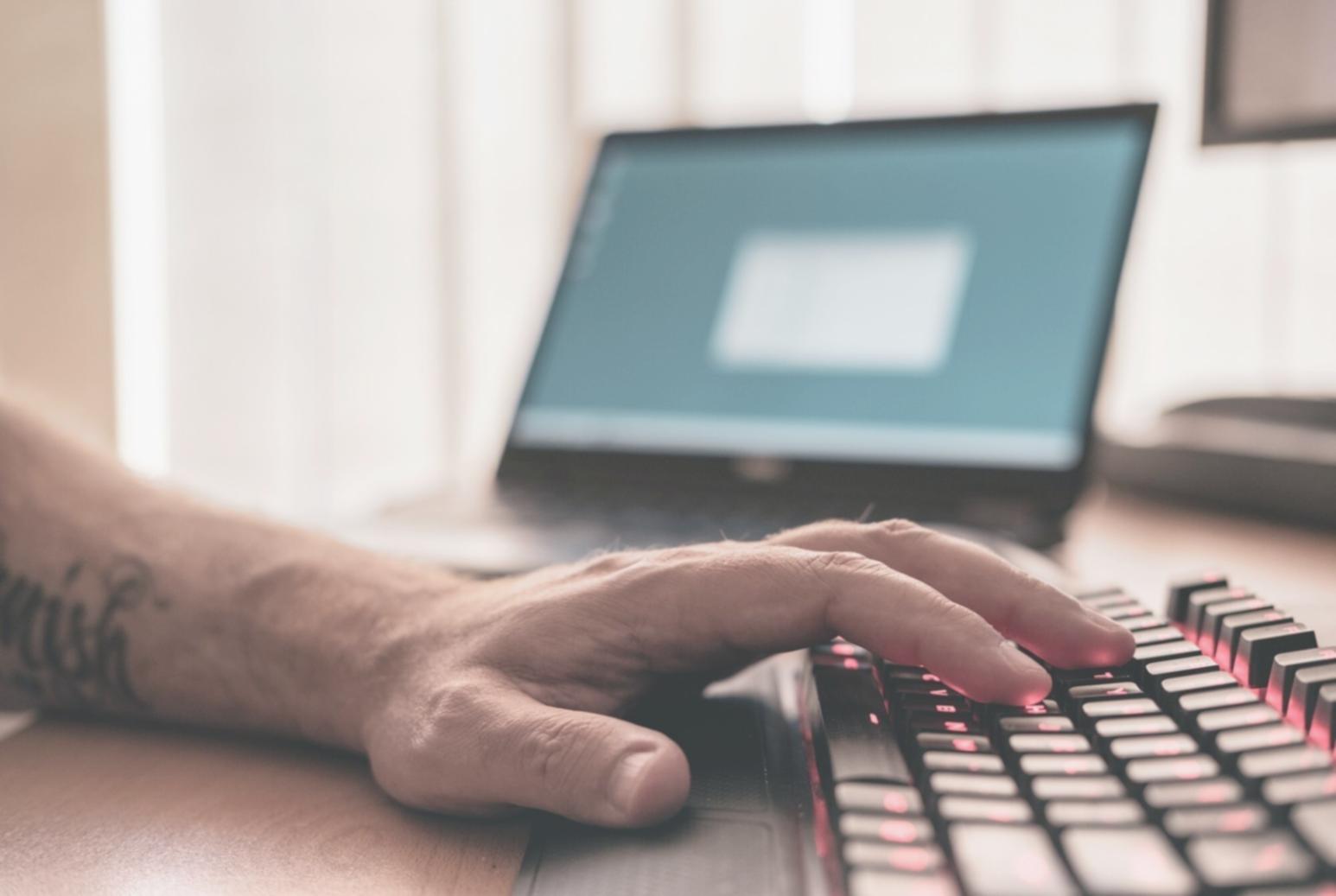 Developer working on mobile app code optimization and debugging on multiple screens